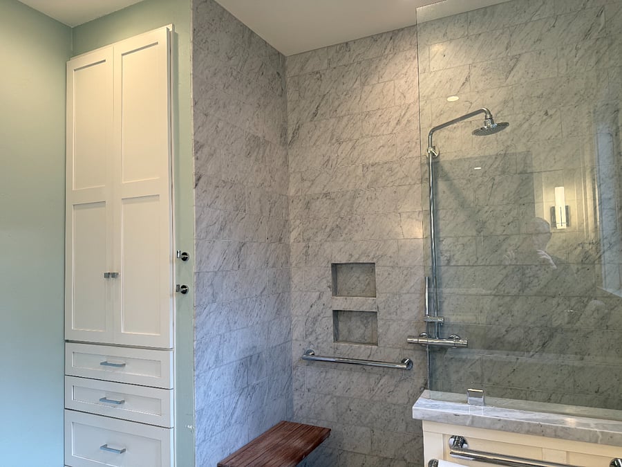 custom cabinetry in the primary bathroom provides ample storage