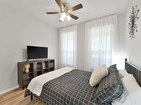 Bedroom 2 with a queen bed and walk in closet. Smart TV in here as well.
