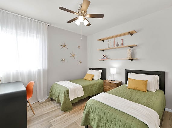 Bedroom 3 with two twin beds and a designated desk space. Sound machine and pack and play in closet if needed