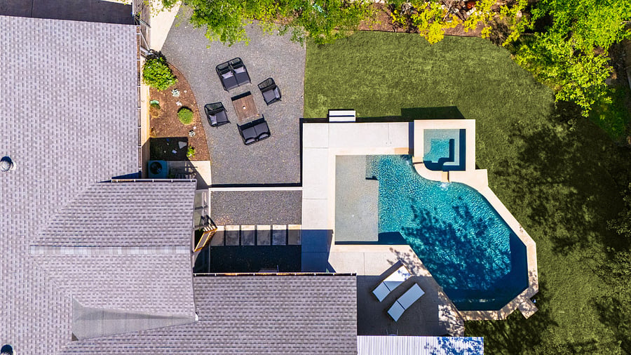 Birds-eye view of your outdoor retreat: cool off in the pool, enjoy food or drink under the covered outdoor dining area, or gather around the firepit for stargazing and smores.