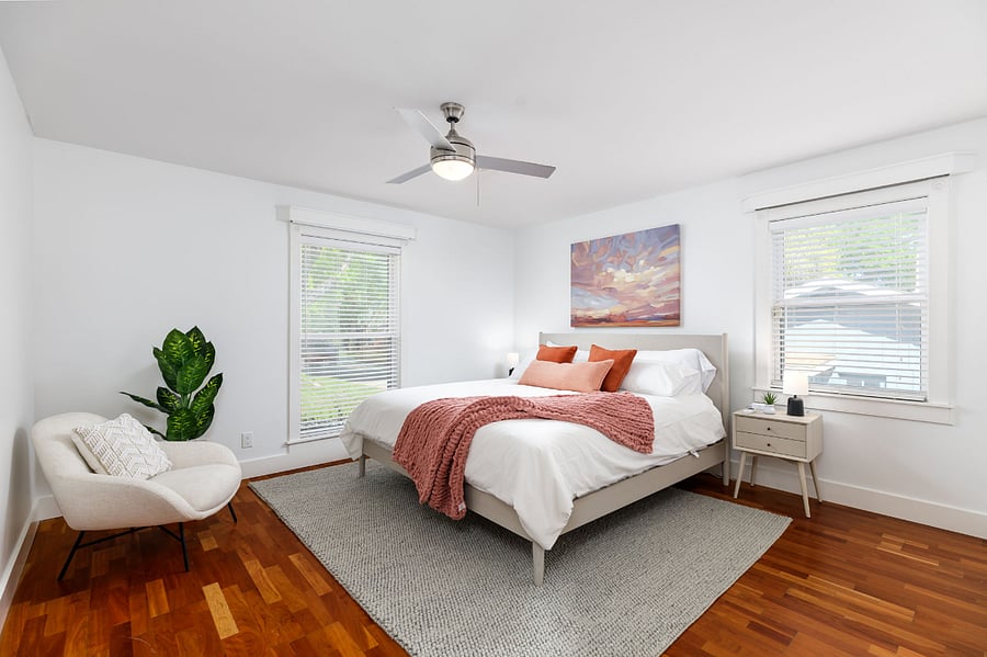 Serene and sunlit master bedroom with cozy king bed, luxe linens, and a splash of color inspired by Austin skies.