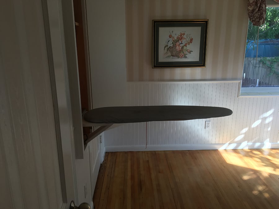 Folding ironing board in master bedroom between the closets. 