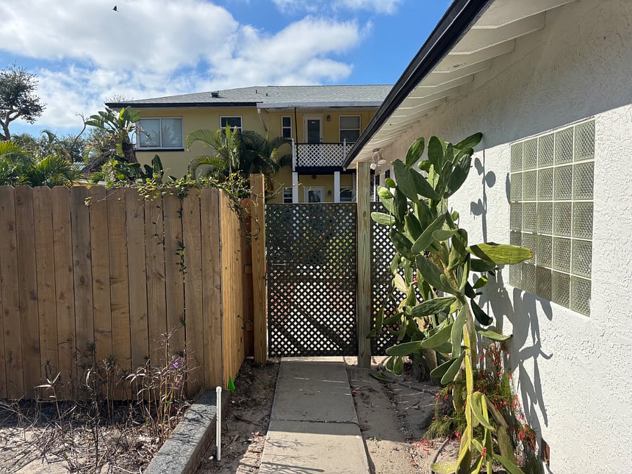 Gated rear entry onto the property from the parking area