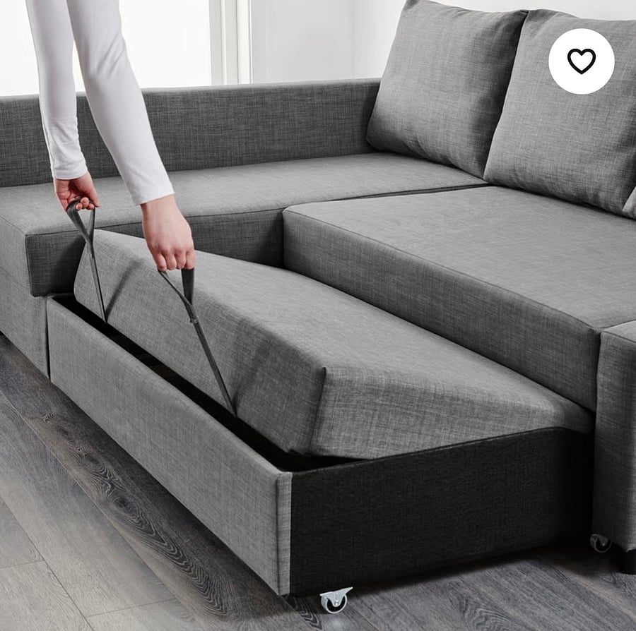 Couch in Living room opens up to a full size bed.