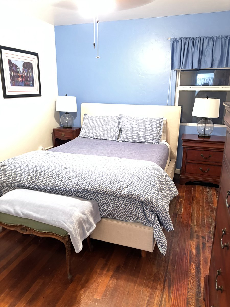 Main bedroom with queen bed, night stands, dresser, and large closet. 