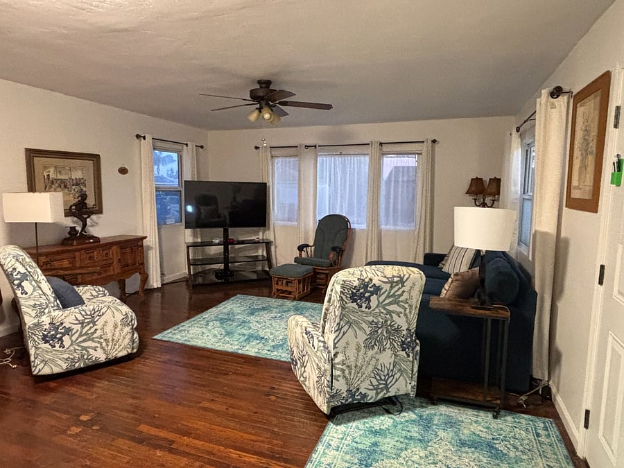 Living room - TV and front windows. Couch is a pull out couch if needed for a guest.