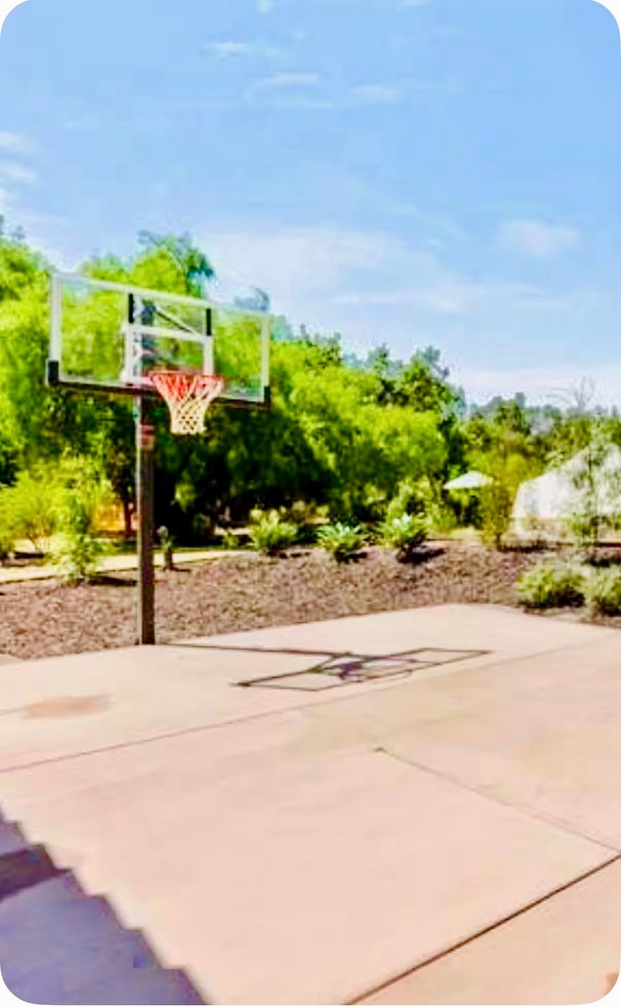 Basketball half-court. Located near swimming pool.