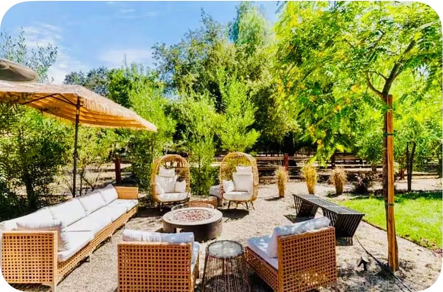 Common outdoor lounge area located next to the horses, giant tipi lawn, and outdoor kitchen/grill.