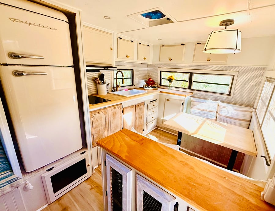 Casita 2 Kitchenette with dining table for up to 4. Cooktop, full size refrigerator w/ freezer, toaster oven, and all basic cooking and dinnerware. Brita water container in fridge for fresh well-water.