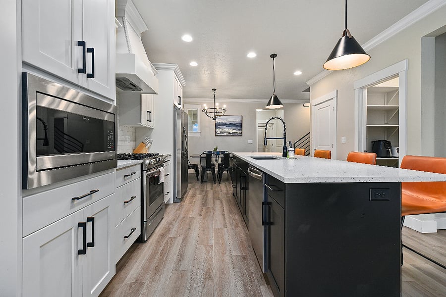 Kitchen featuring a large island with four modern barstools and all appliances in excellent working condition.