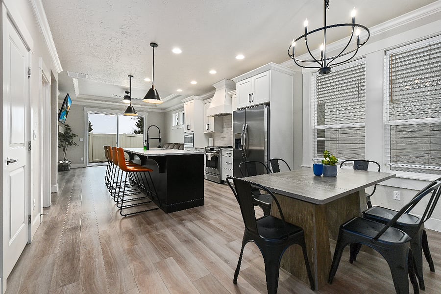 Kitchen featuring a large island with four modern barstools and all appliances in excellent working condition.