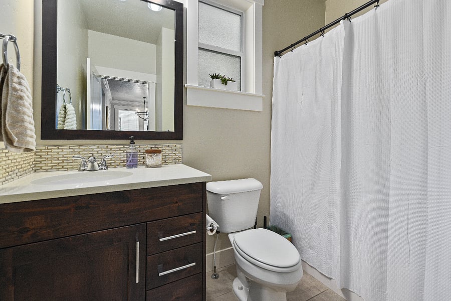 Full downstairs bathroom featuring a tub and shower combination.