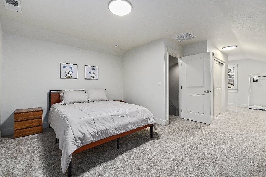 Upstairs bedroom featuring a queen-size bed and two three-drawer dressers