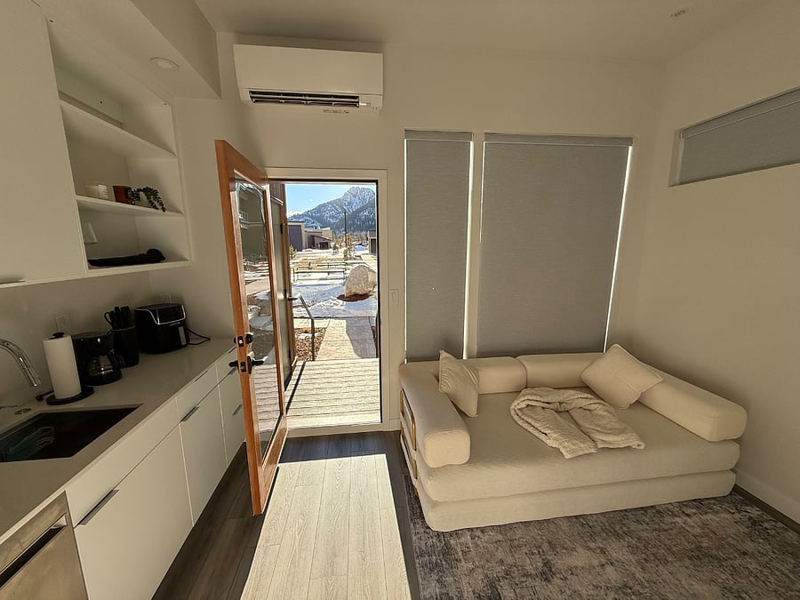 Bright living area with natural light and mountain views.