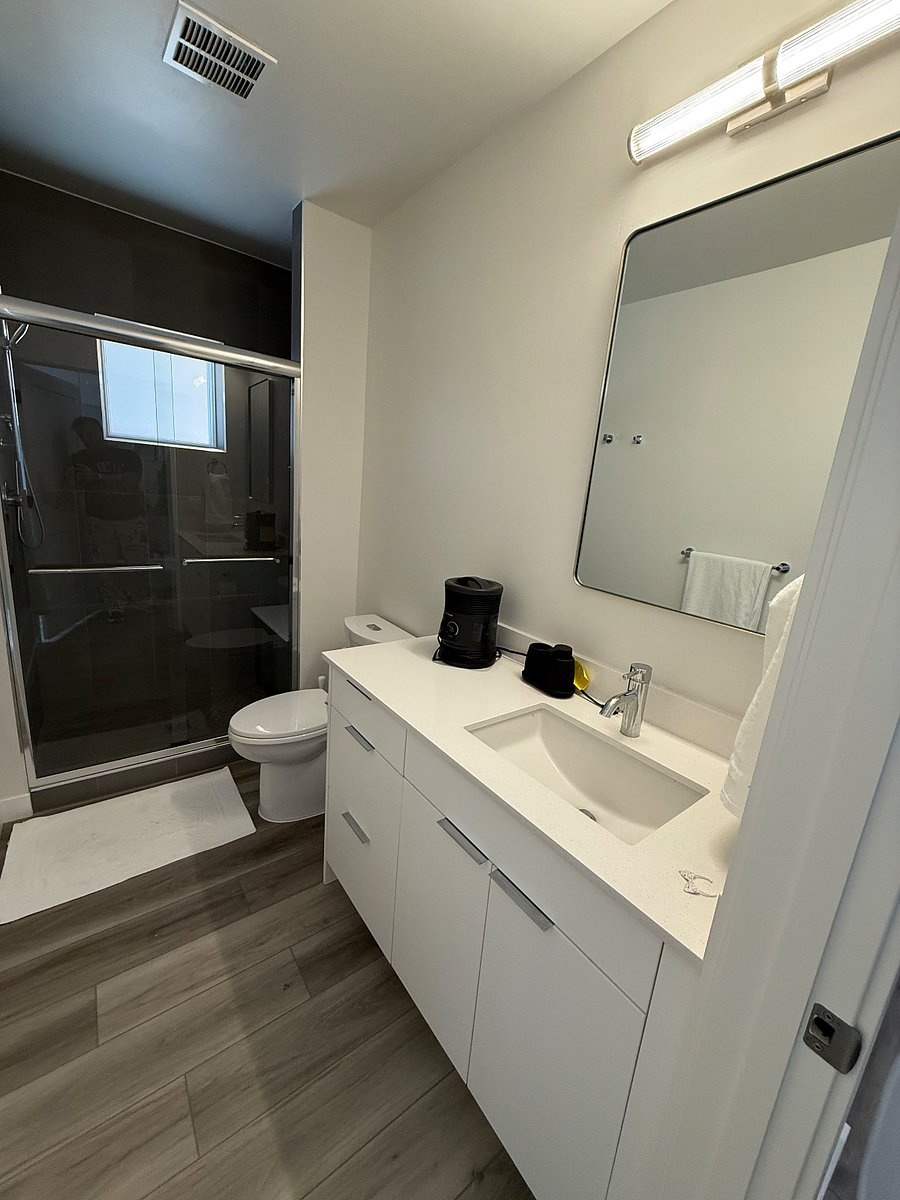 Modern bathroom with walk-in shower and sleek finishes.
