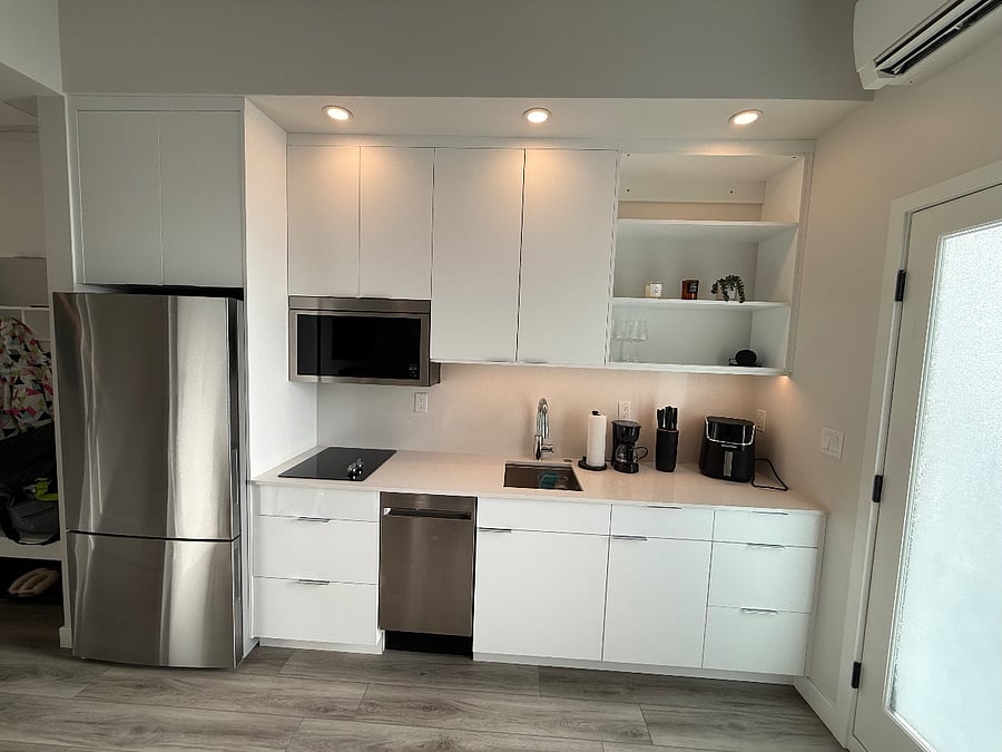 Fully equipped modern kitchen with stainless steel appliances.