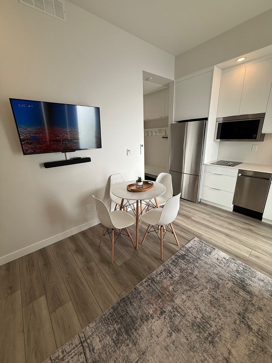 Dining area with smart TV, perfect for work or relaxing.