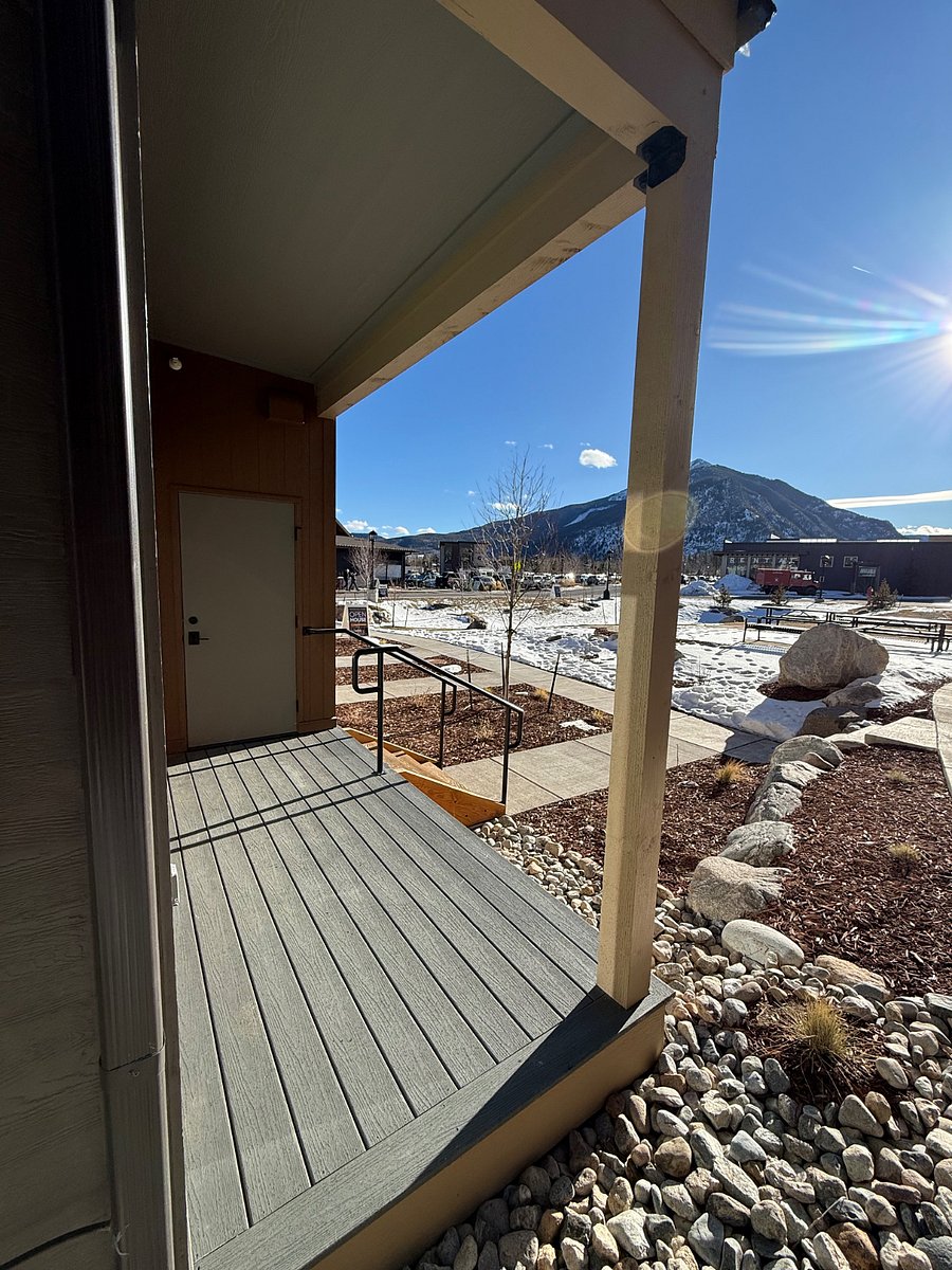 Private covered entrance with outdoor seating area.