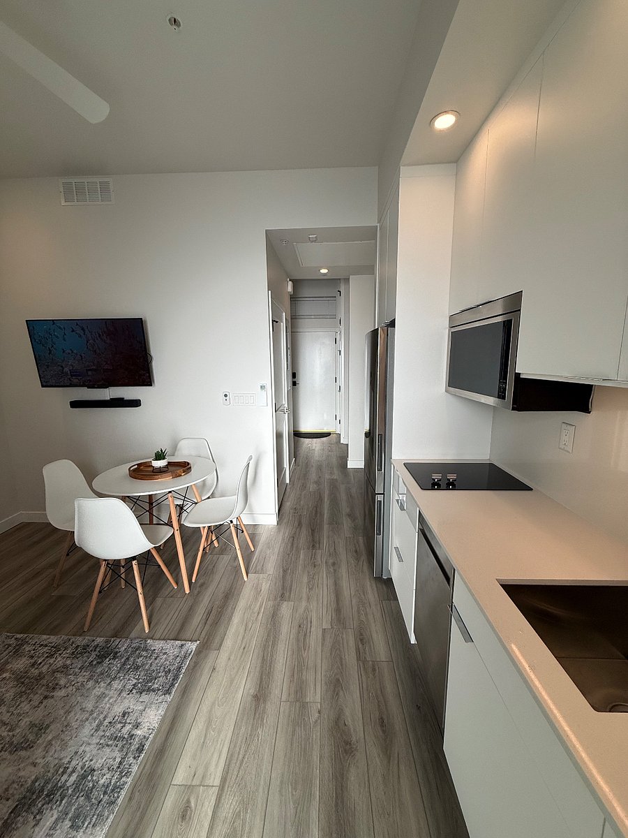 Open-concept living area with full kitchen, dining space, and excellent natural light. Smart layout that feels larger than expected for a studio.