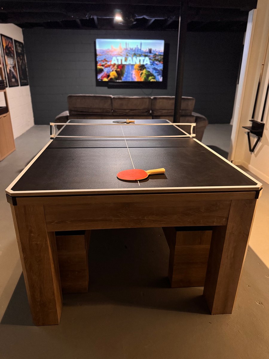 Versatile game room featuring a pool table that converts to ping-pong or a dining/card table.