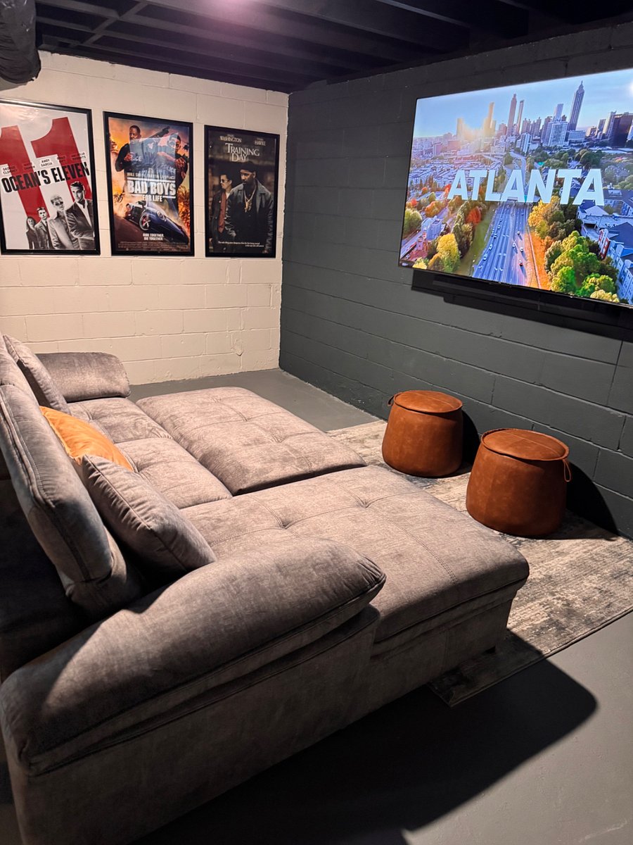 Cozy media room with a pop-out sleeper sofa, full bedding and linens perfect for movie nights or extra sleeping space.