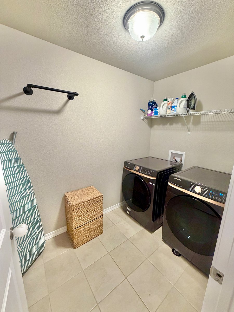 A convenient laundry room is available with a washer and dryer, starter washing supplies, laundry baskets, and an iron with ironing boardmaking day-to-day living easy and stress-free.