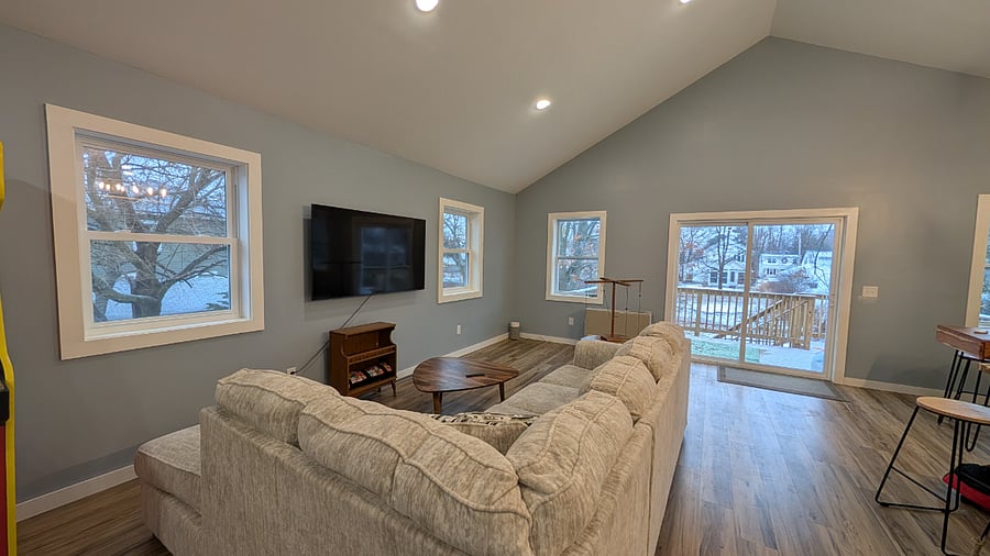 Open living/dining/kitchen area with large TV