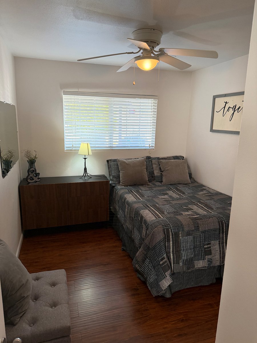 Interior view of bedroom from inside bedroom showcasing the furniture and fully functional window