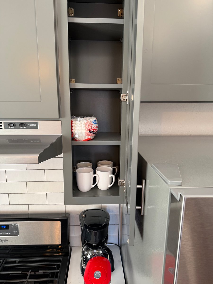 Interior view of cabinets with kitchen items