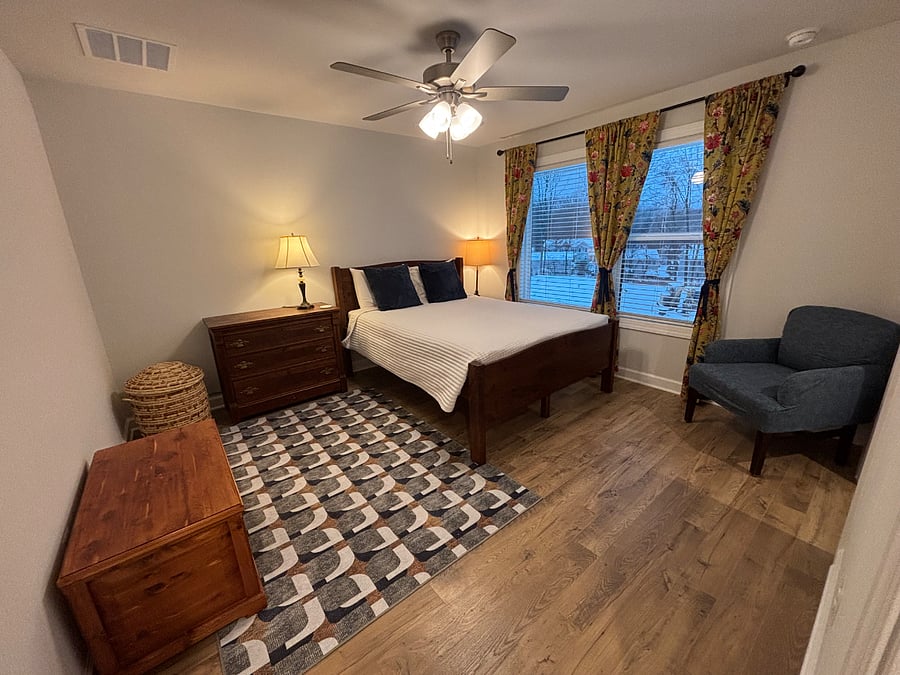 Primary bedroom with queen bed, walk-in closet, and en-suite bath
