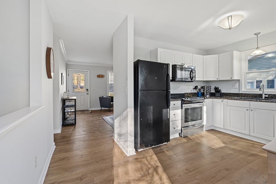Kitchen with full size fridge, microwave, range, dishwasher, garbage disposal, coffee maker, and crockpot. All pots/pans, spices, dishes, mugs, flatware, etc. provided.