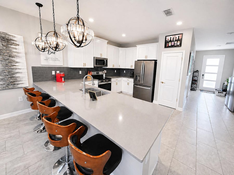 Spacious kitchen with a large breakfast bar, ample cabinetry, and stainless steel appliances for easy daily cooking.