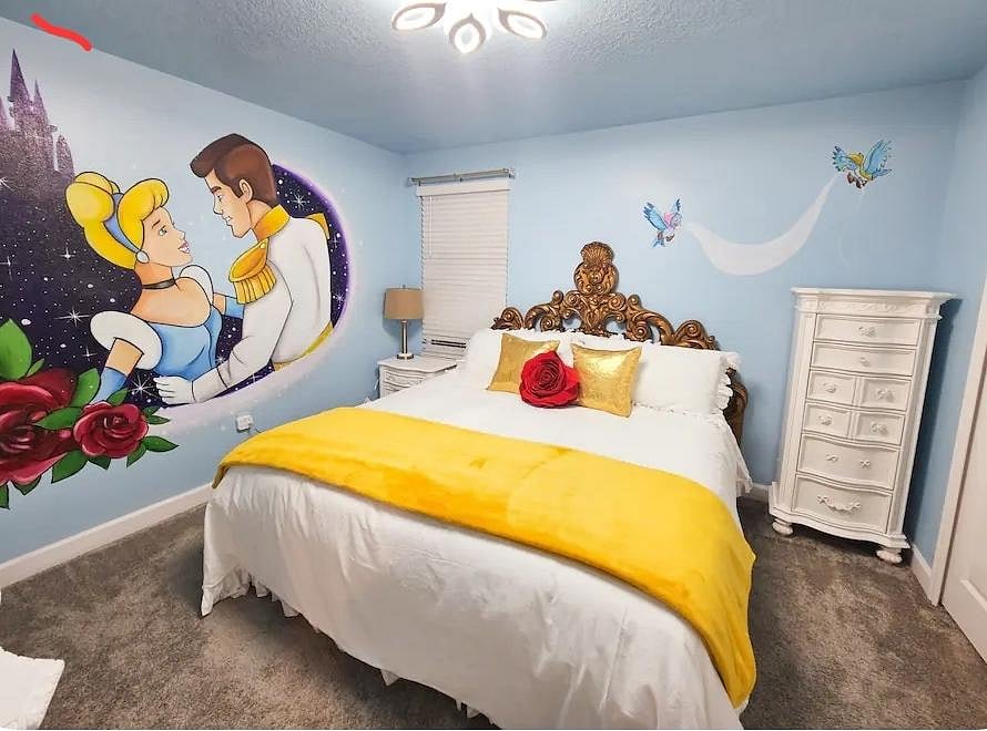 Furnished bedroom featuring a full bed, bedside table with lamp, dresser storage, and carpeted floors with a window.