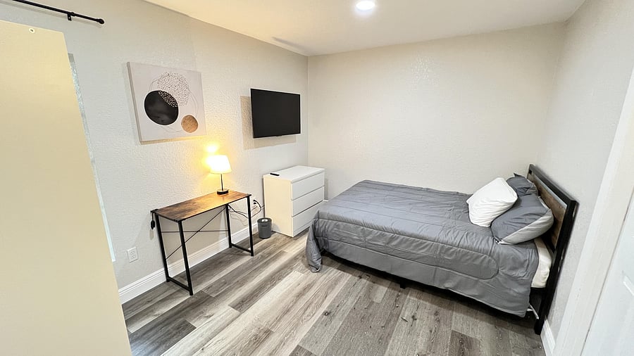 Bright, airy room with large window, cozy bed, and work desk.Ideal for natural light lovers seeking comfort and productivity.