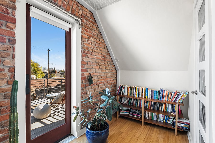 Upstairs bedroom #2 with door leading to an outdoor rooftop patio