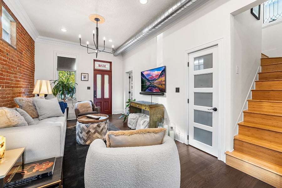 Living room on the main level with view of the front door
