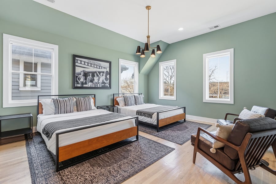 Bedroom 2 includes a queen and king bed, two accent chairs, and a smart TV with access to all the streaming apps. It also has a huge walk-in closet and large ensuite bathroom.