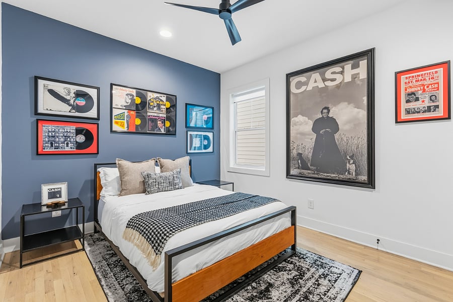 Queen sized bed with modern music decor in bedroom 2. Has smart TV with access to all the streaming apps and a closet.