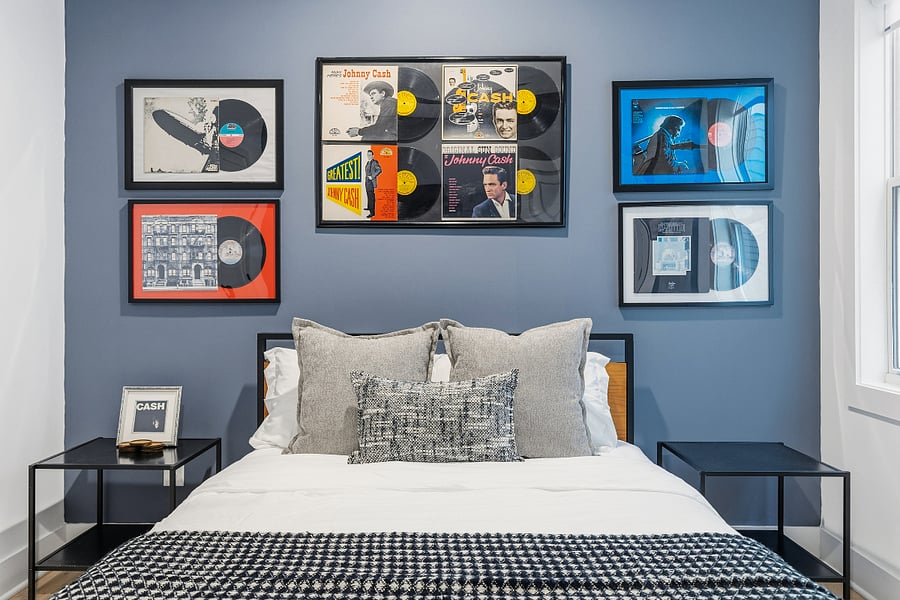 Queen sized bed with modern music decor in bedroom 2. Has smart TV with access to all the streaming apps and a closet.