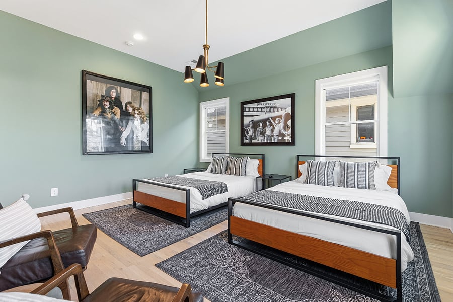 Bedroom 2 includes a queen and king bed, two accent chairs, and a smart TV with access to all the streaming apps. It also has a huge walk-in closet and large ensuite bathroom.