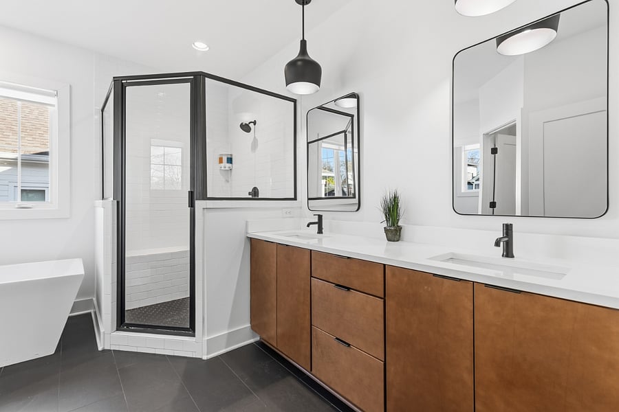 Beautiful, ensuite bath attached to bedroom 2 with standing shower, separate bathtub, and 2 sinks.