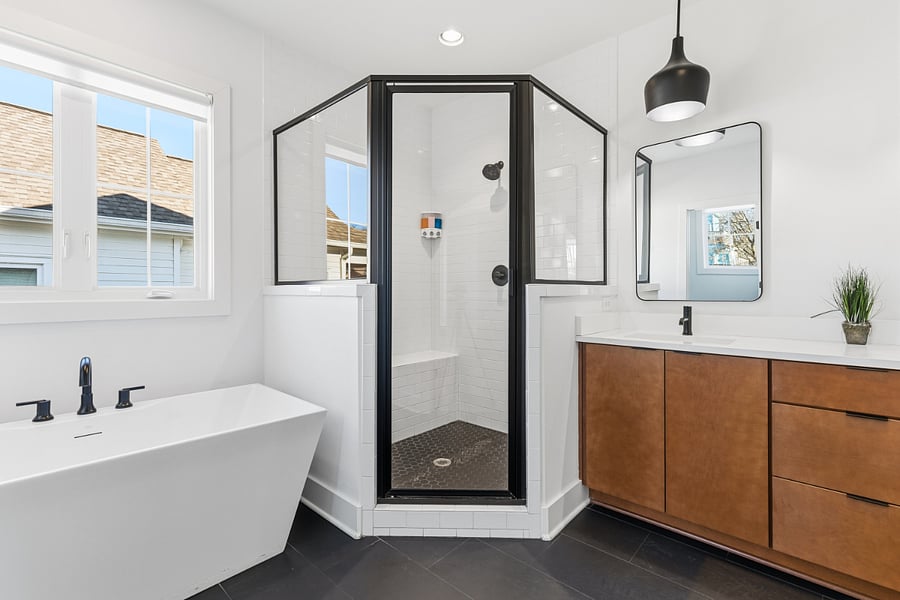 Beautiful, ensuite bath attached to bedroom 2 with standing shower, separate bathtub, and 2 sinks.