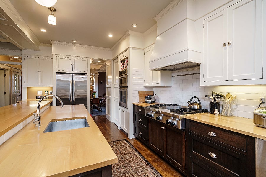 Kitchen with gas range and island prep sink with wine refridgerator