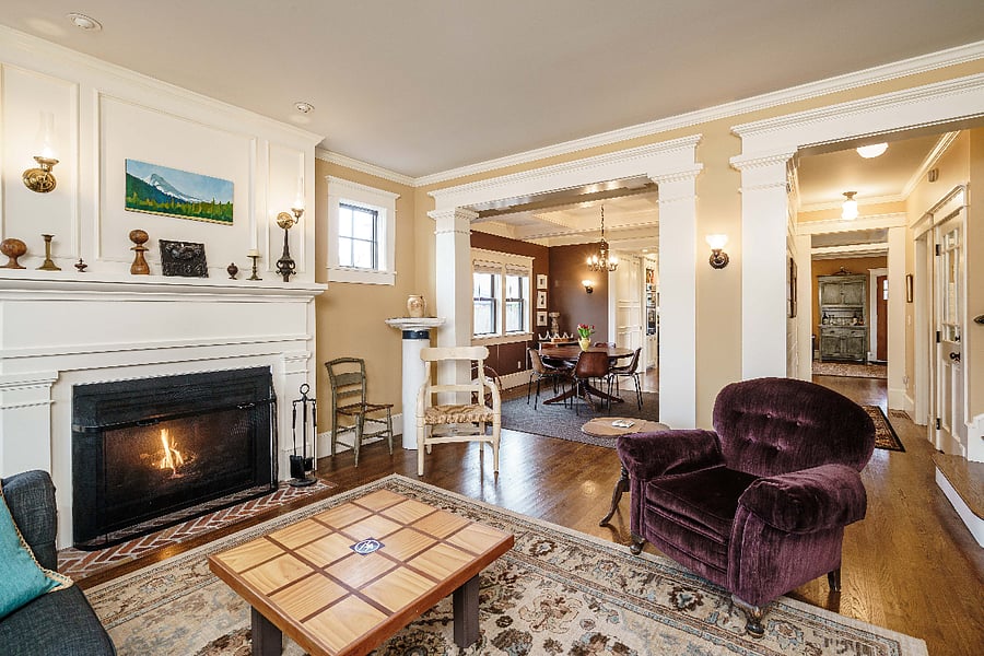 Living room with gas fireplace looking into dining room and hallway to kitchen