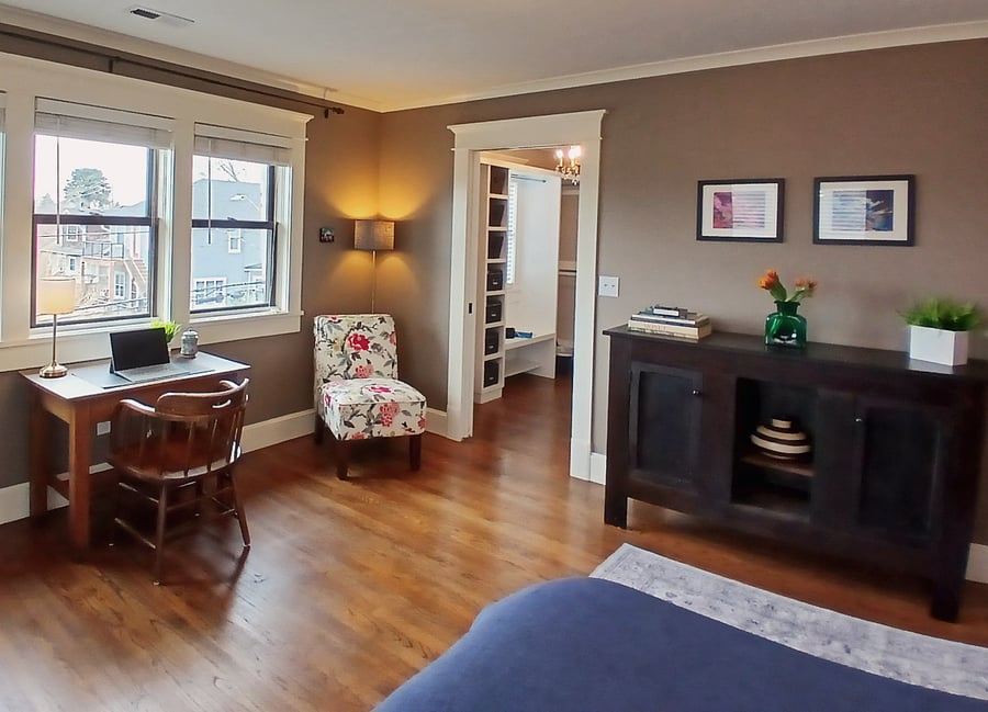 Work space, sitting area and storage hutch in private main suite bedroom