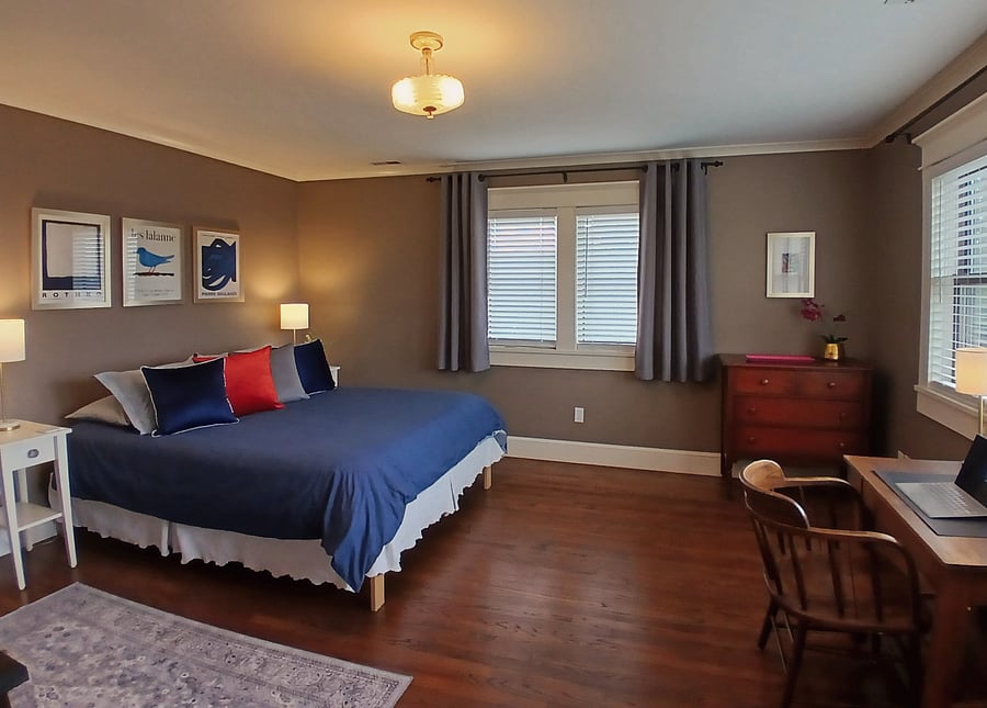 Private main suite with queen bed, work space, sitting area, walk-in closet and huge bathroom