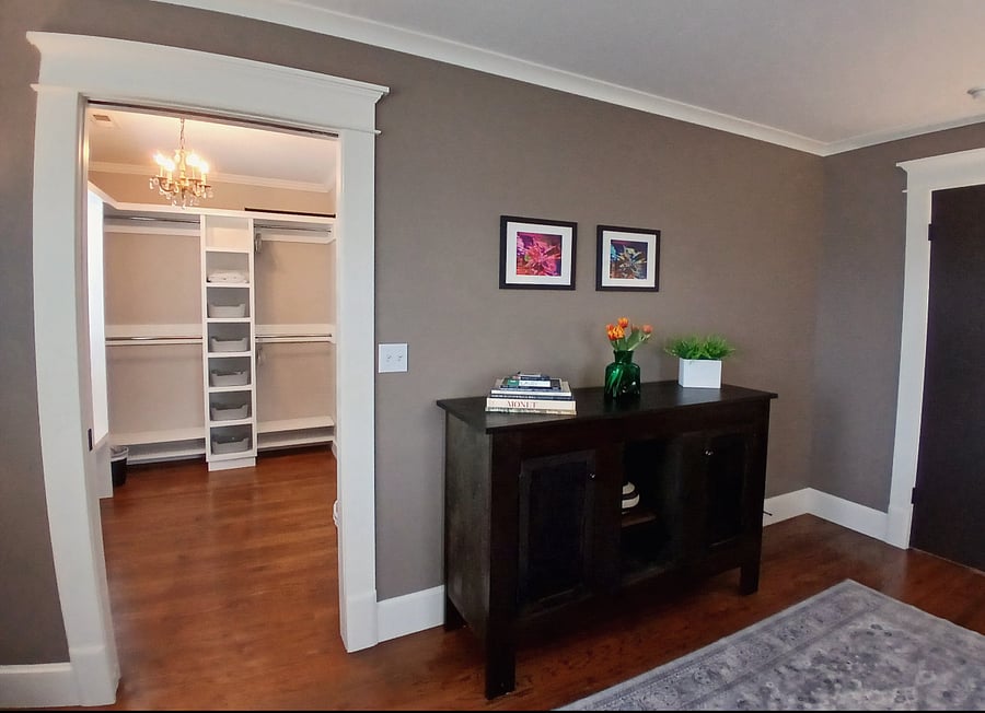 Private main suite bedroom looking into large walk-in closet