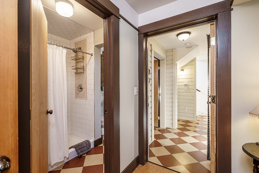 Private bathroom with large, tiled shower on left and secure interor entry to main house on right