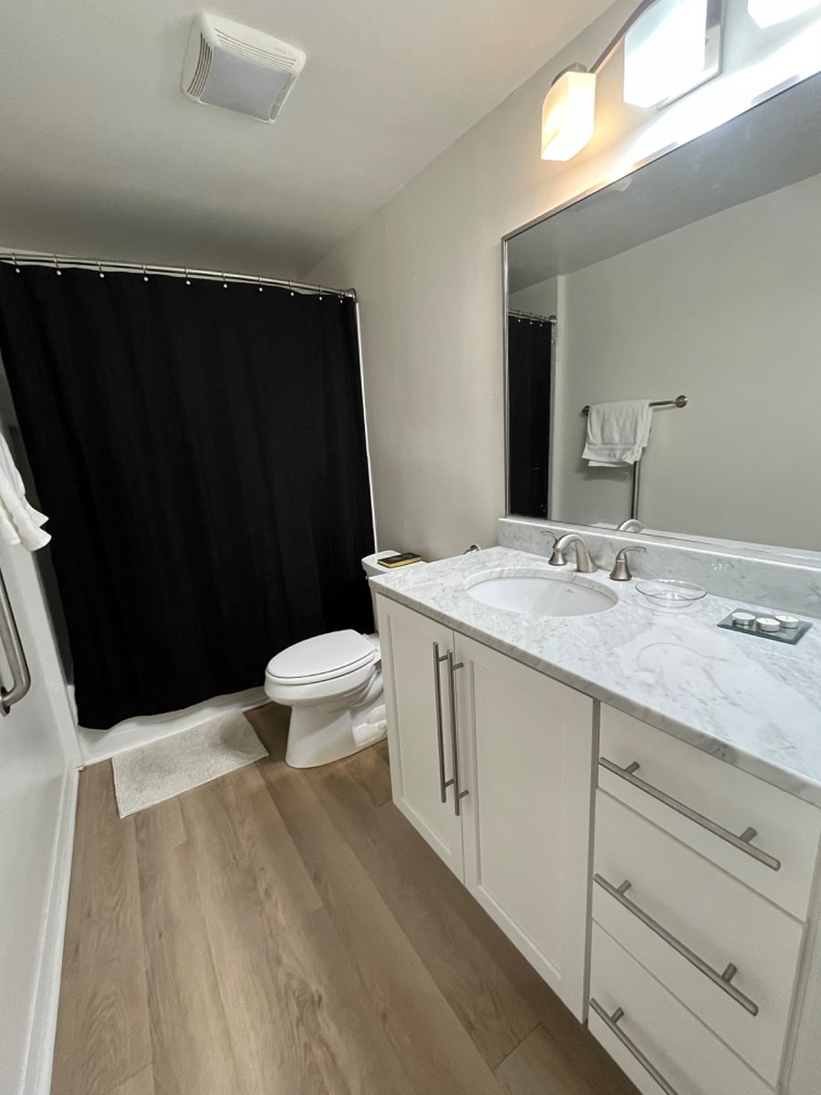 Full bath with tub and shower, ample storage in vanity and utility closet.