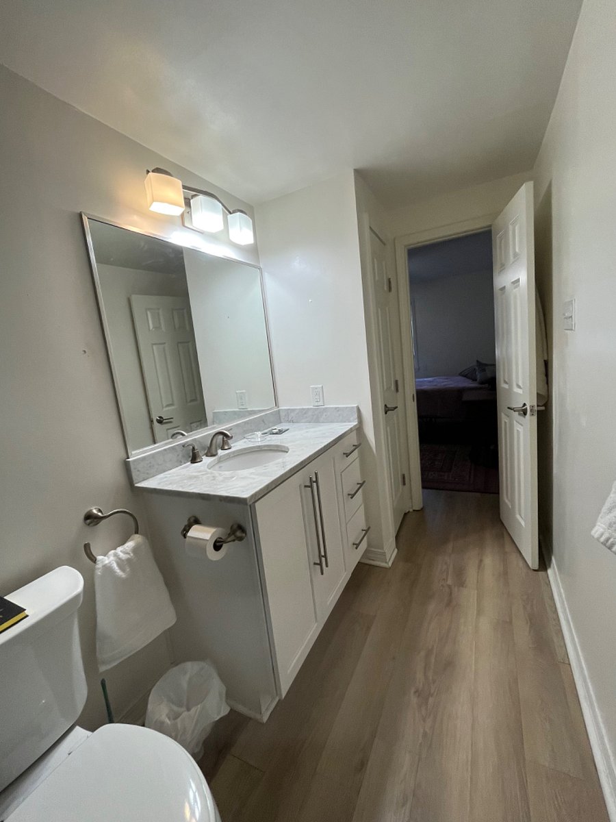 Full bath with tub and shower, ample storage in vanity and utility closet.
